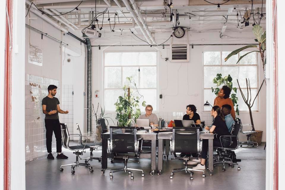 6 people around table in office, discussing "Should I ask my investors if they have capital reserves?"